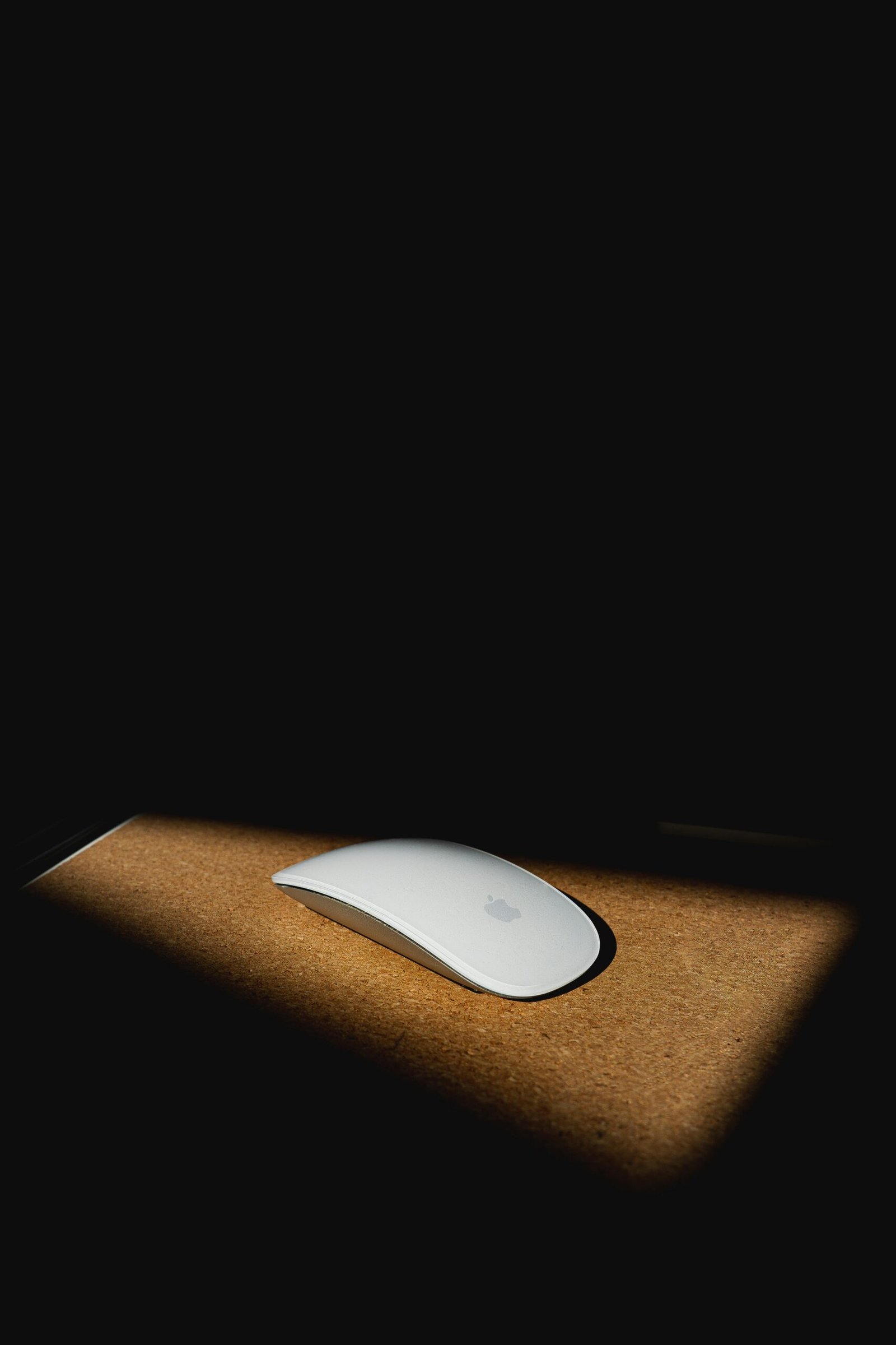 apple magic mouse on brown wooden table